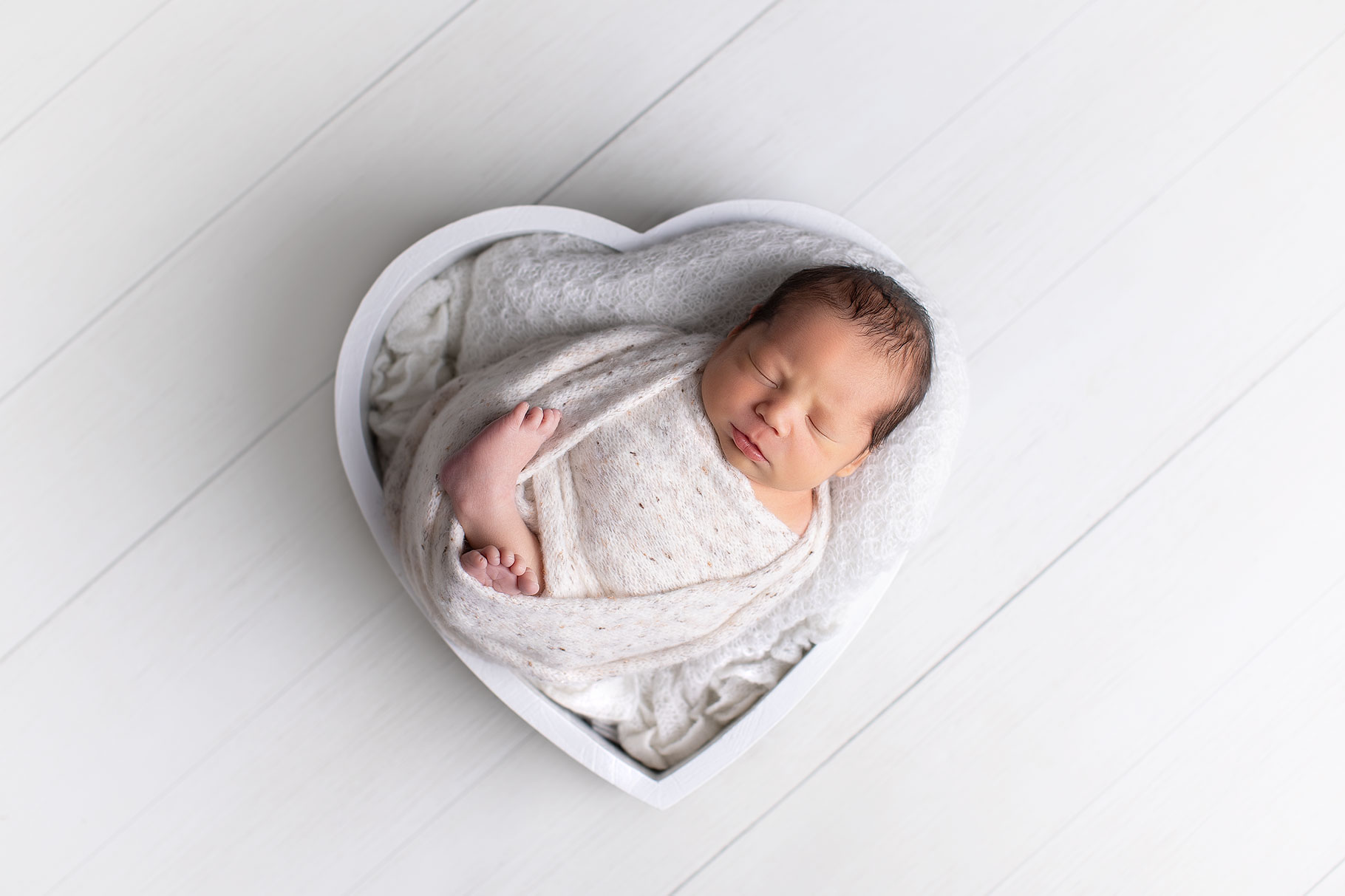 Newborn baby in heart posing