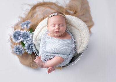 Baby wrapped in blue wrap for newborn session