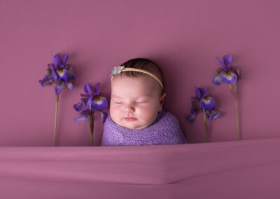 Baby sleeping with irises around her