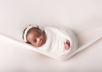 Newborn baby wrapped in white wrap