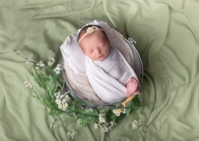 Newborn baby girl with daisy's